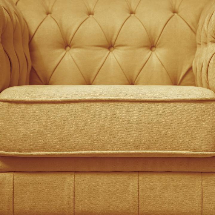 Sillón Chesterfield con capitoné real tapizado en tela